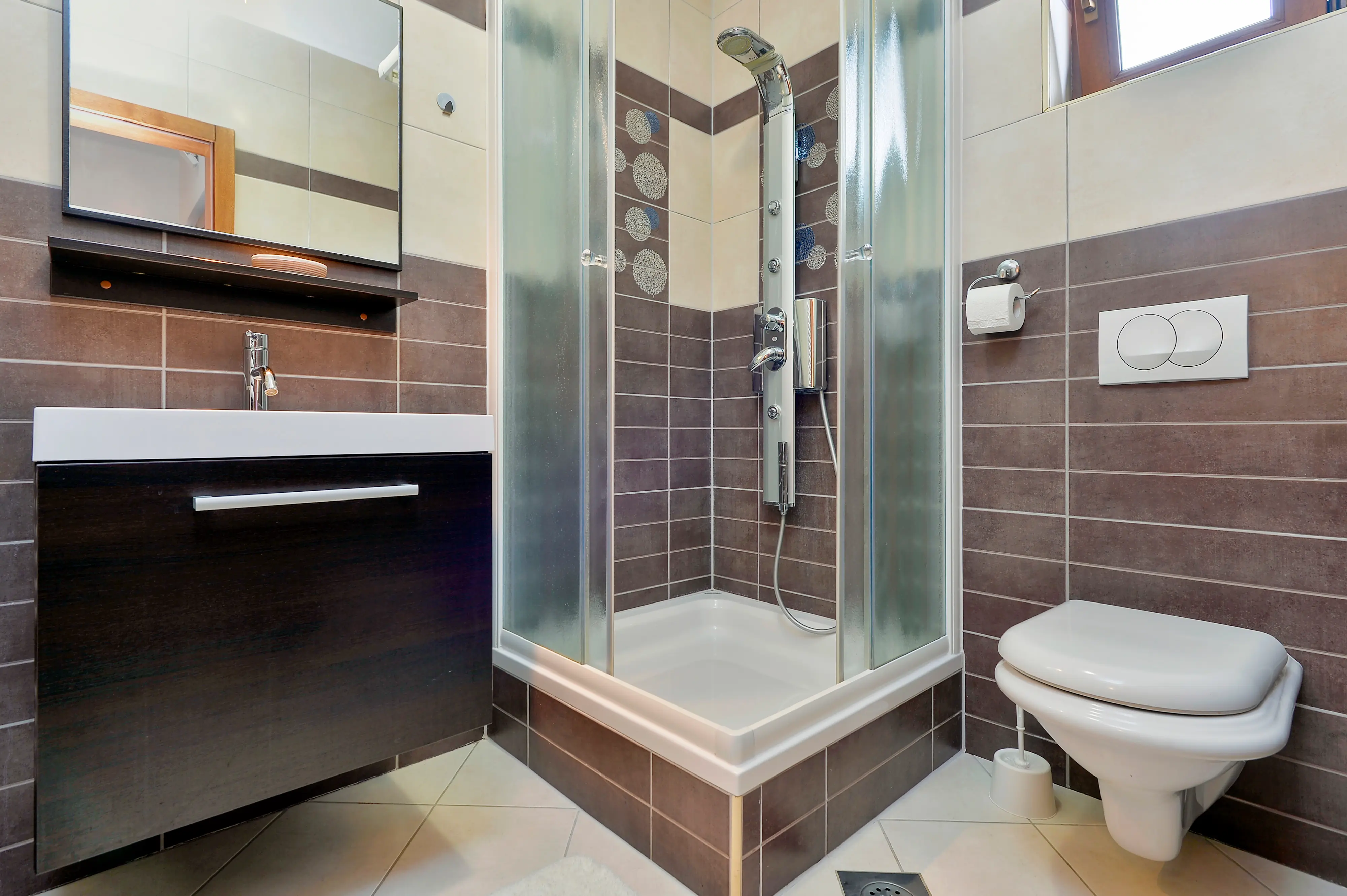 Bathroom showing shower, toilet, and vanity edge