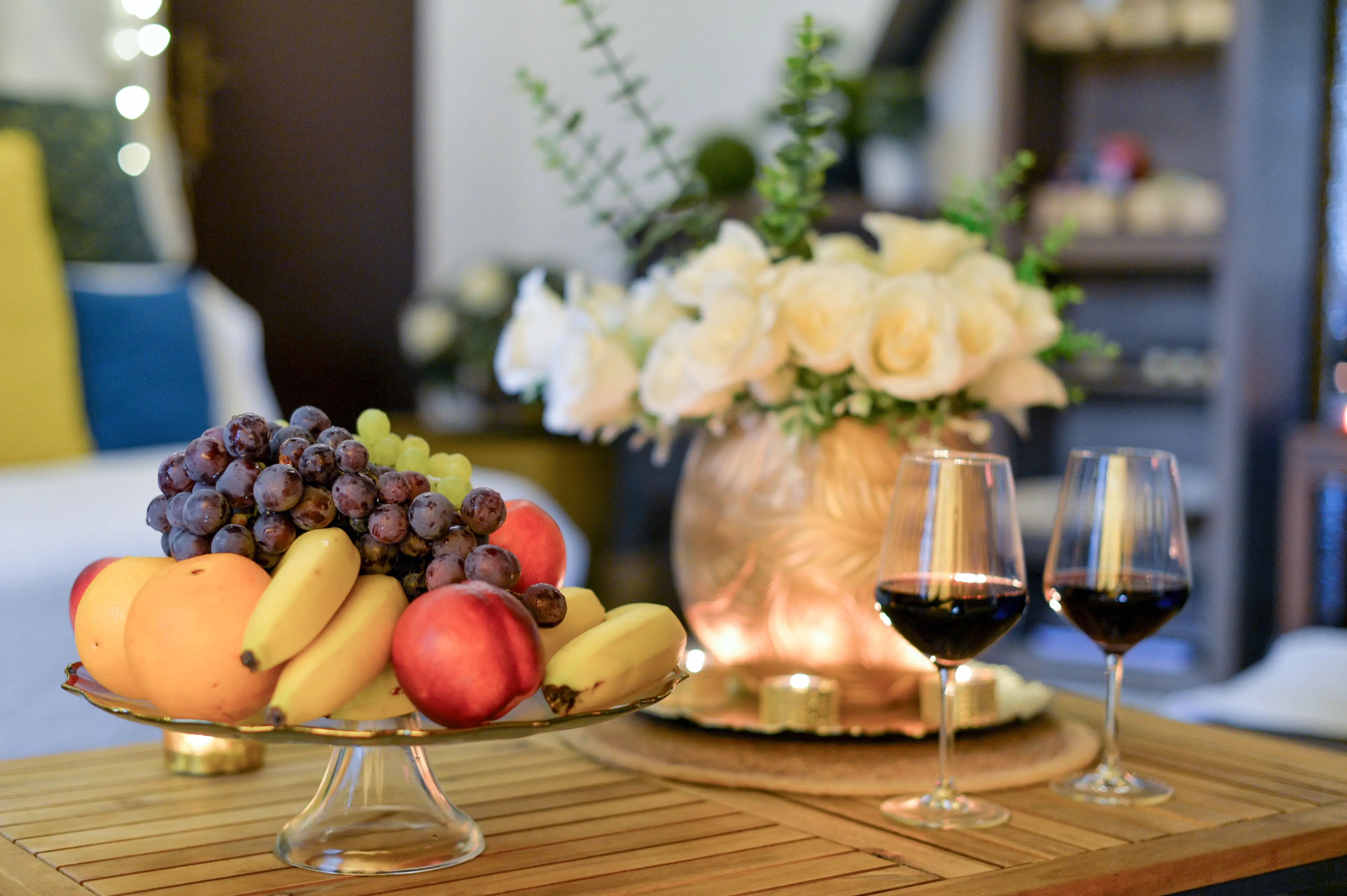 Fruit platter and two wine glasses on table