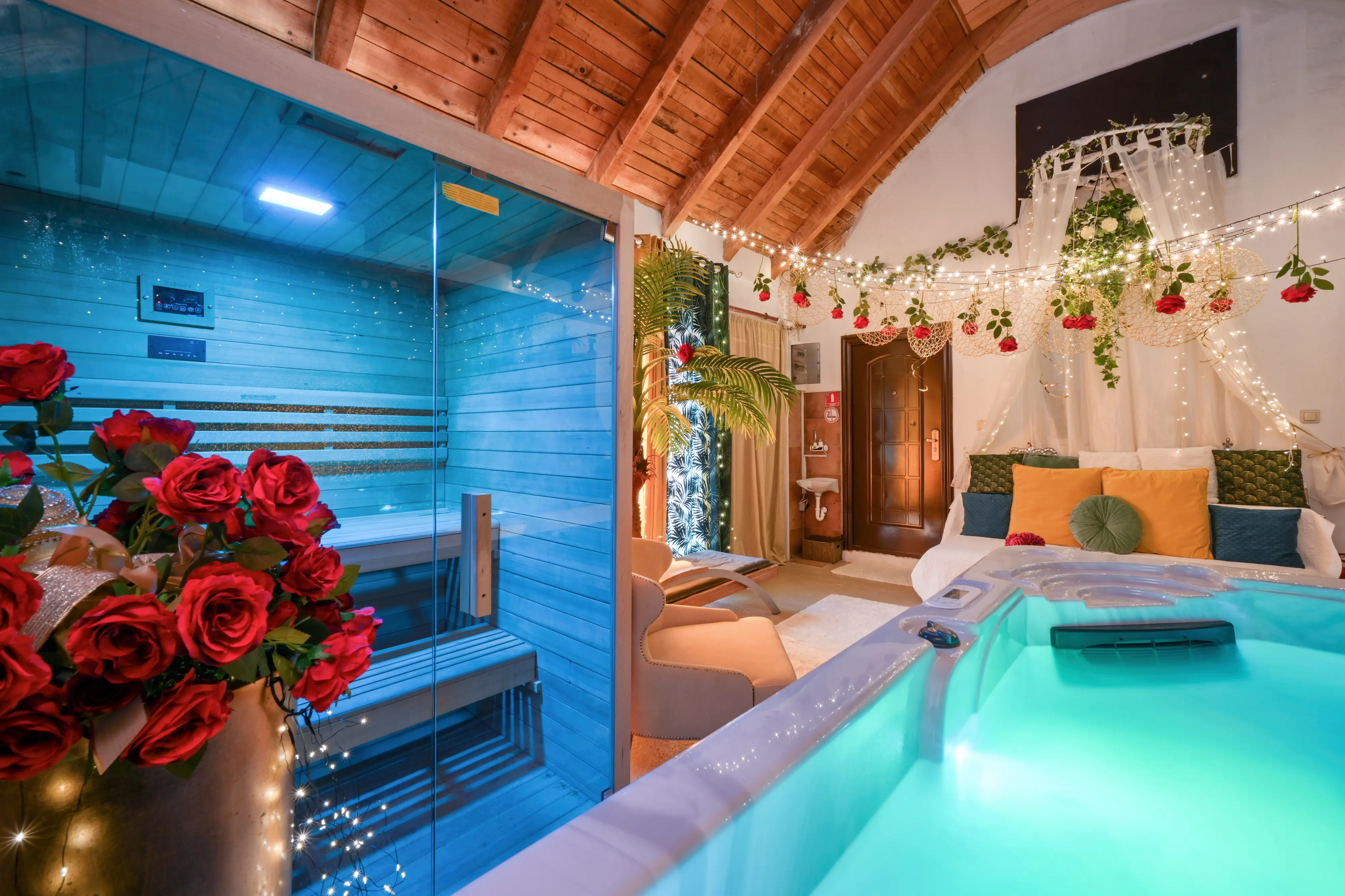 Close indoor spa shot with jacuzzi rim, sauna, and red roses