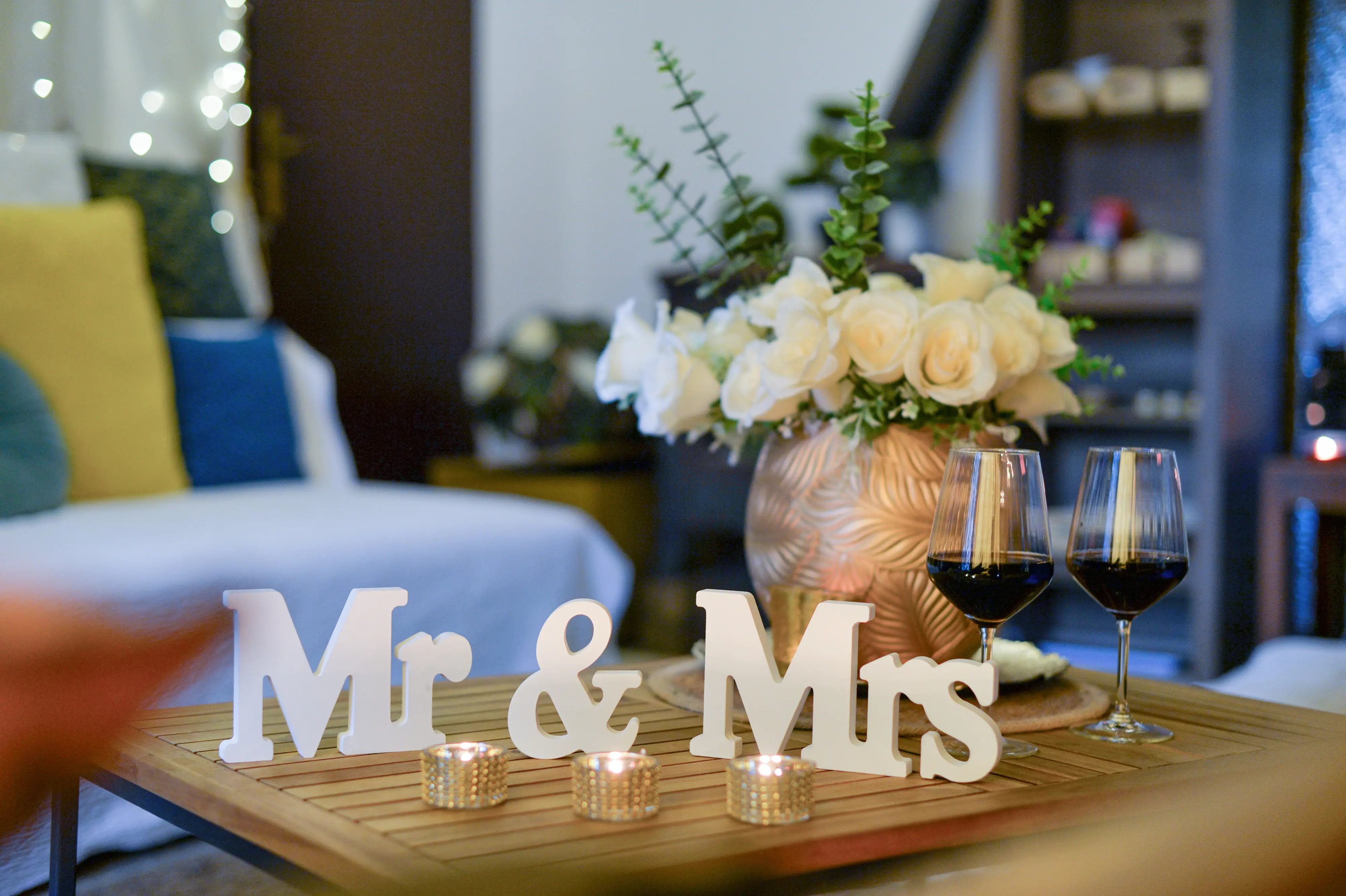 Wooden Mr & Mrs sign with glasses and warm lights