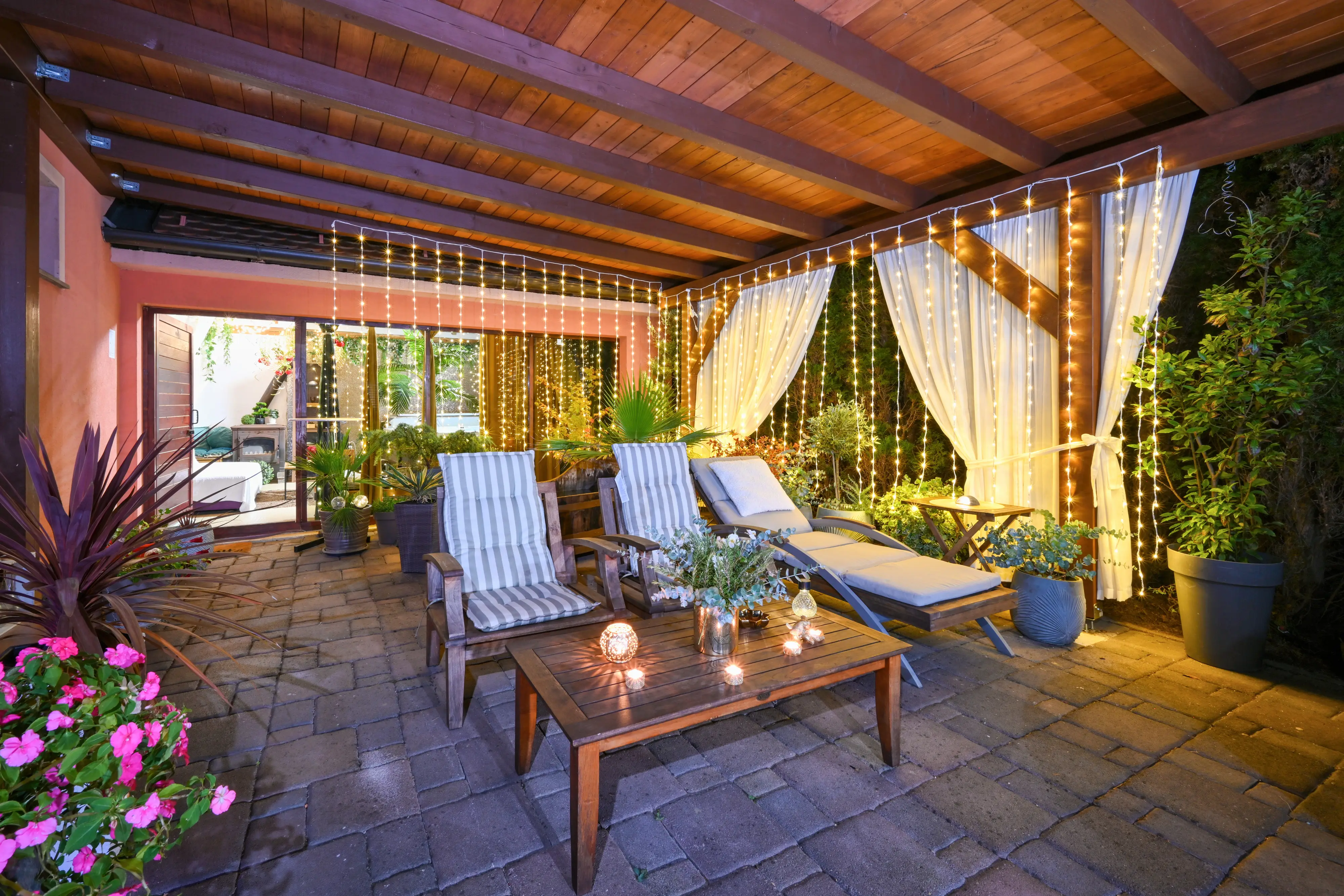 Daytime patio lounge under striped awning with candles