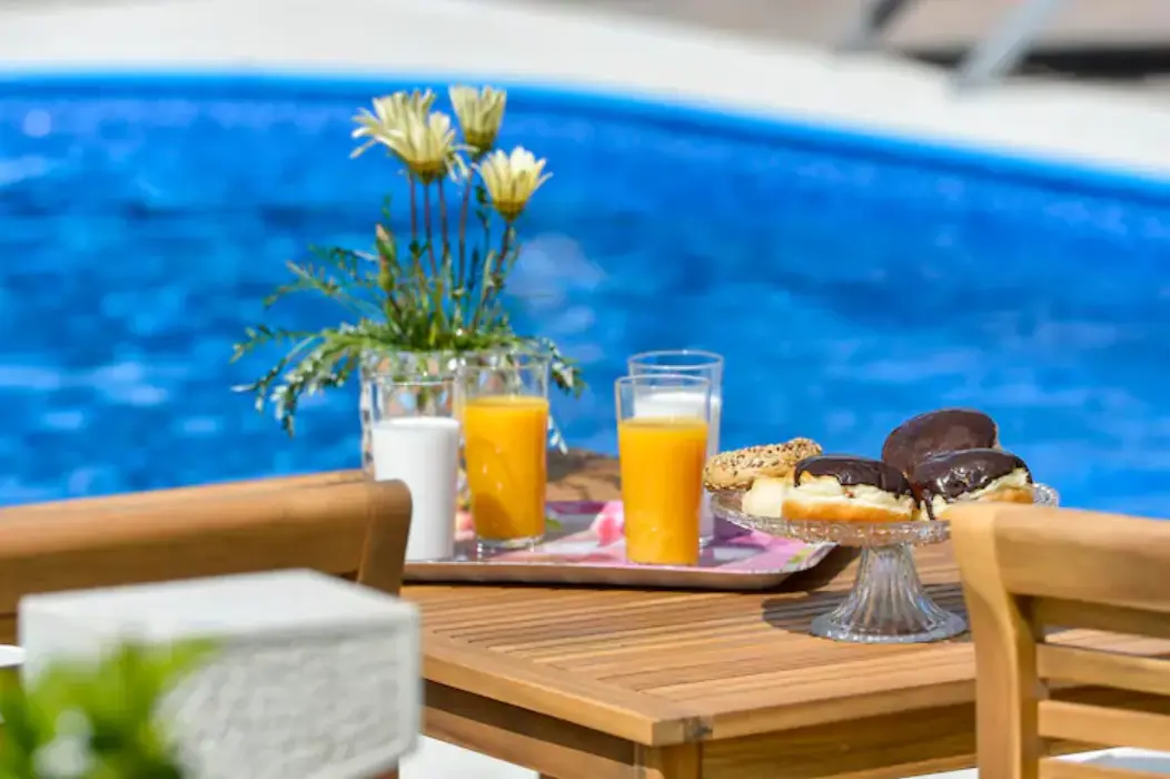 Soft-focus pool detail with flowers and drinks