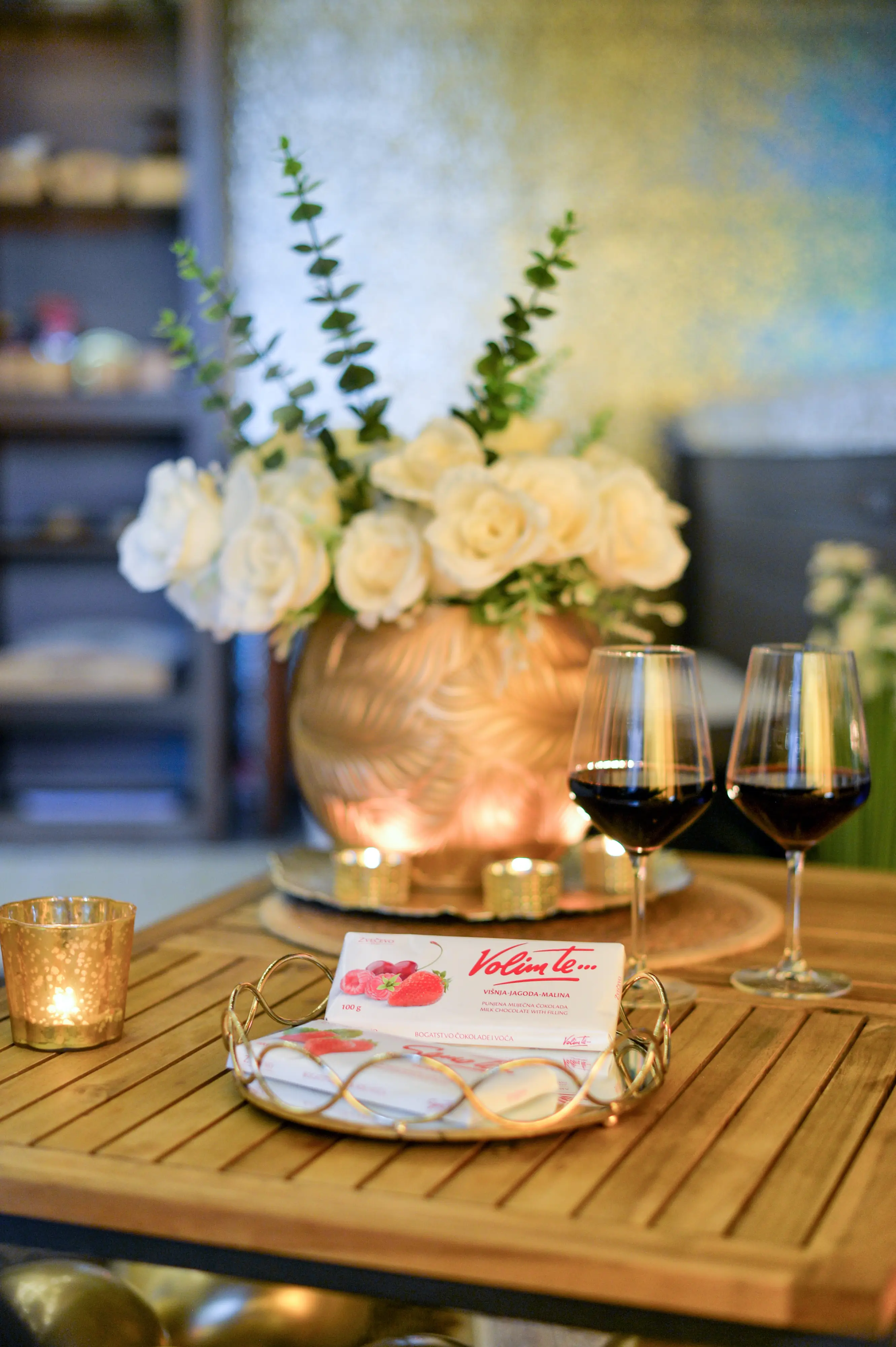 Bouquet, wine glasses, and Valentine card on table
