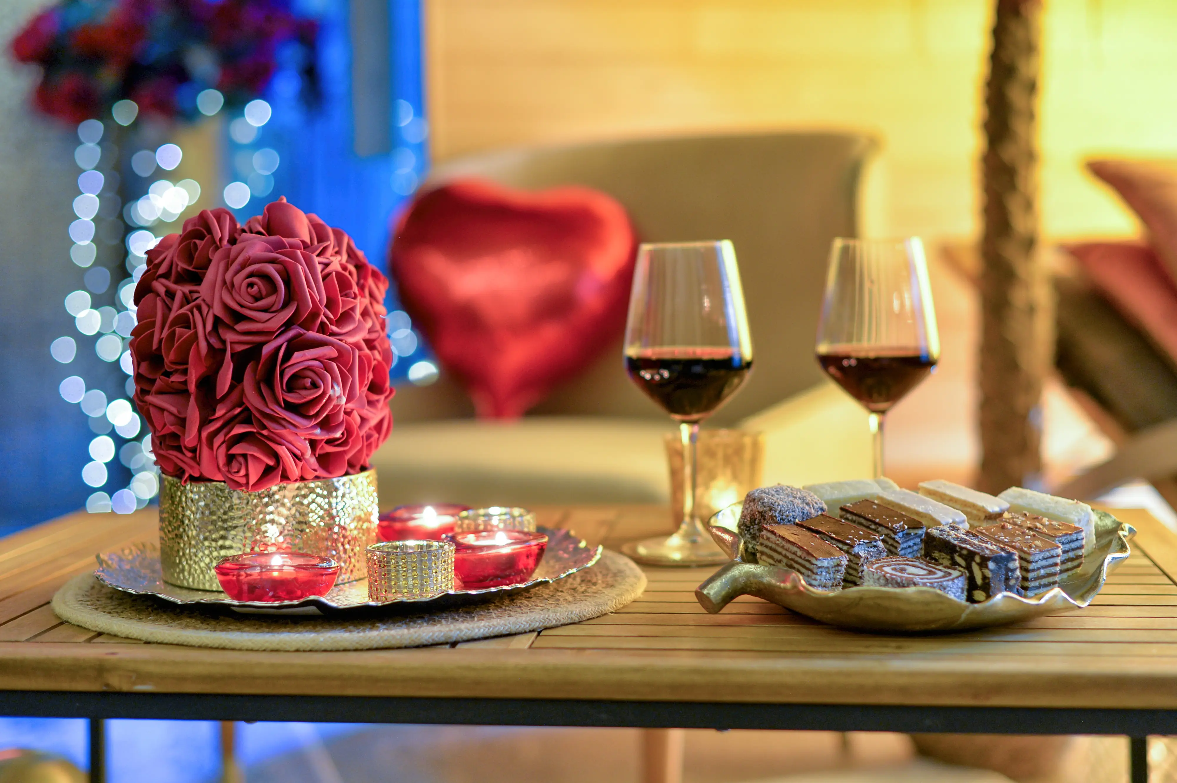 Roses and wine glasses on romantic tray