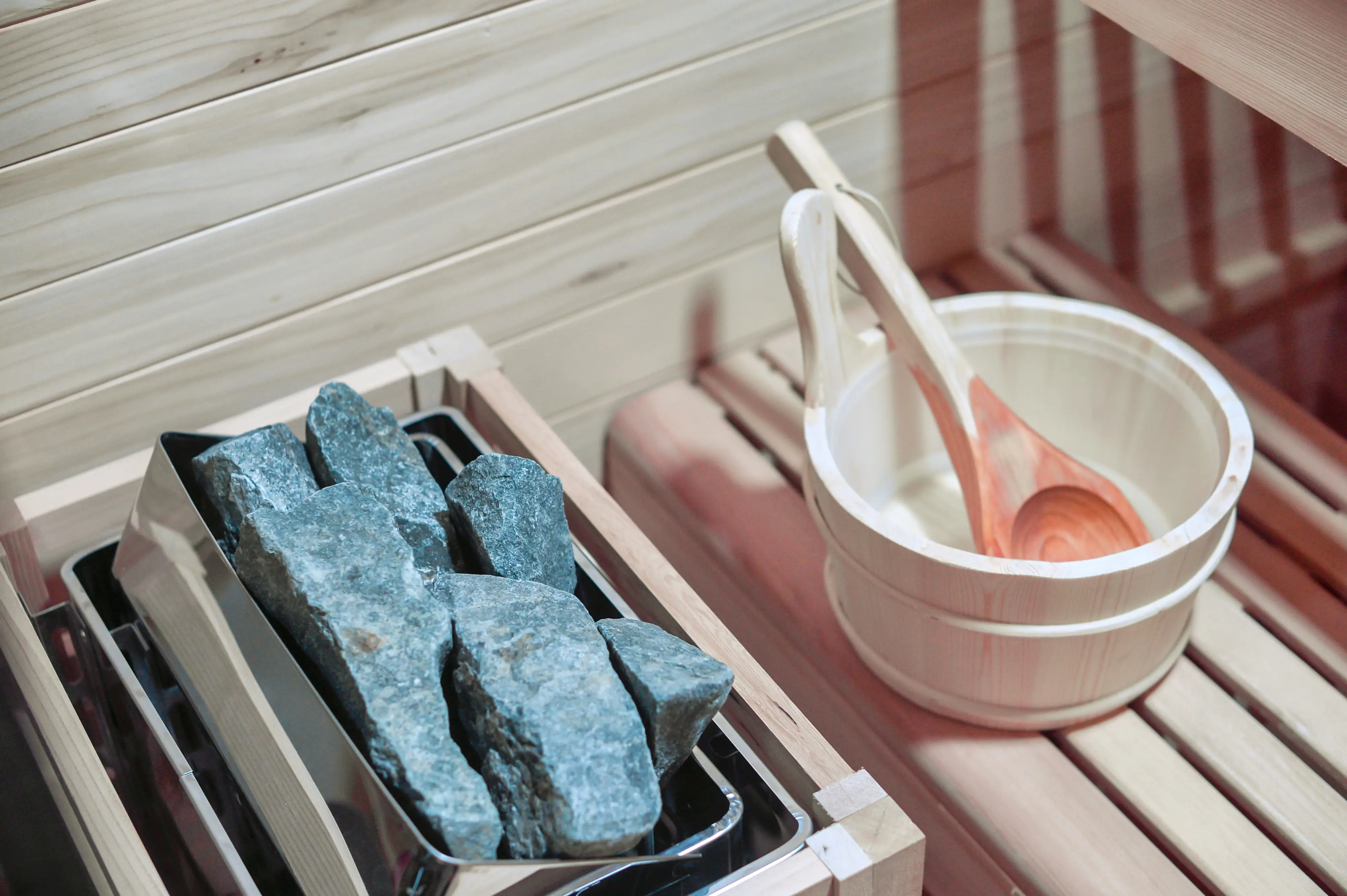 Sauna stones, bucket, and ladle close-up