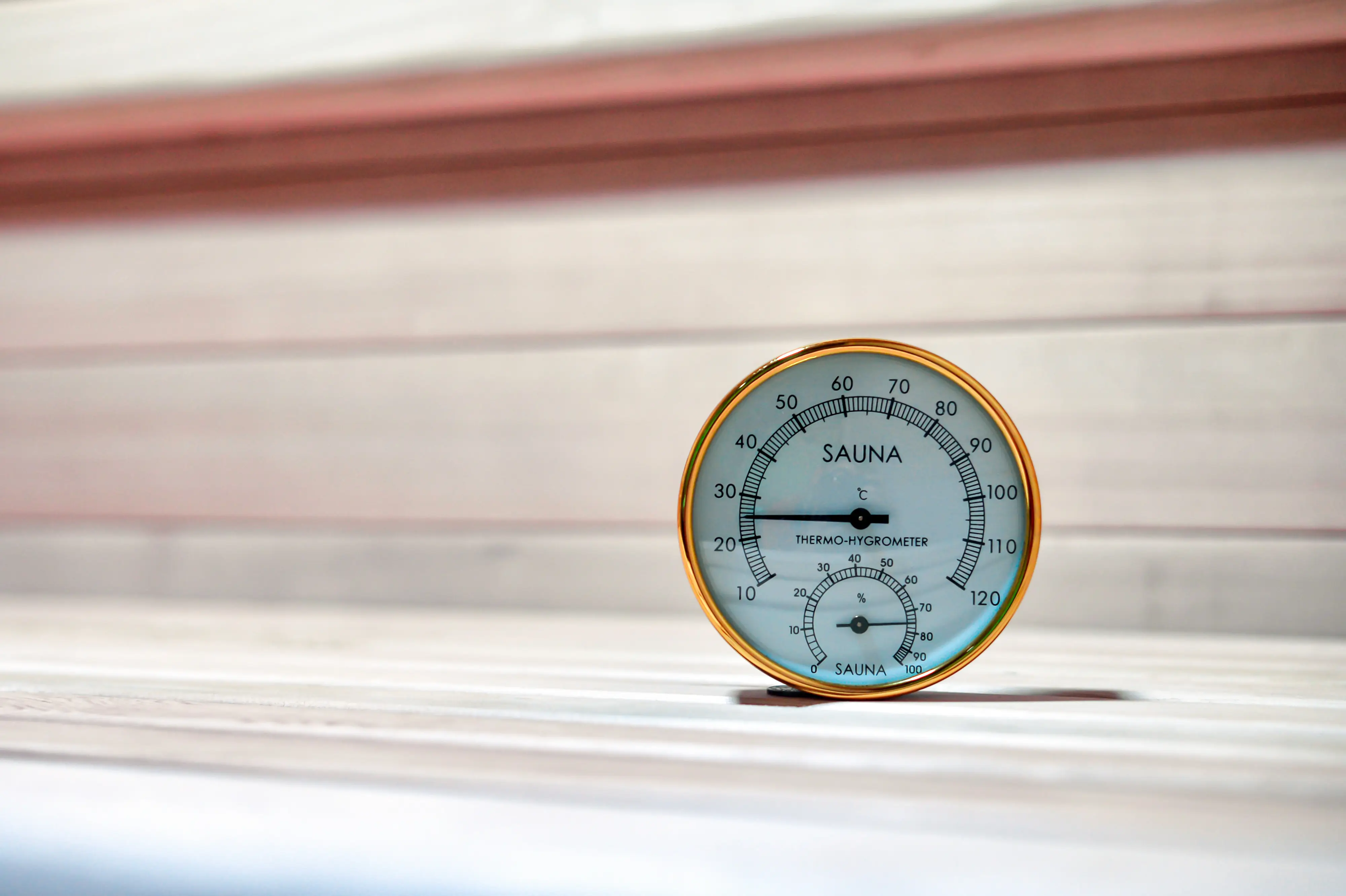 Sauna thermometer close-up on wood wall