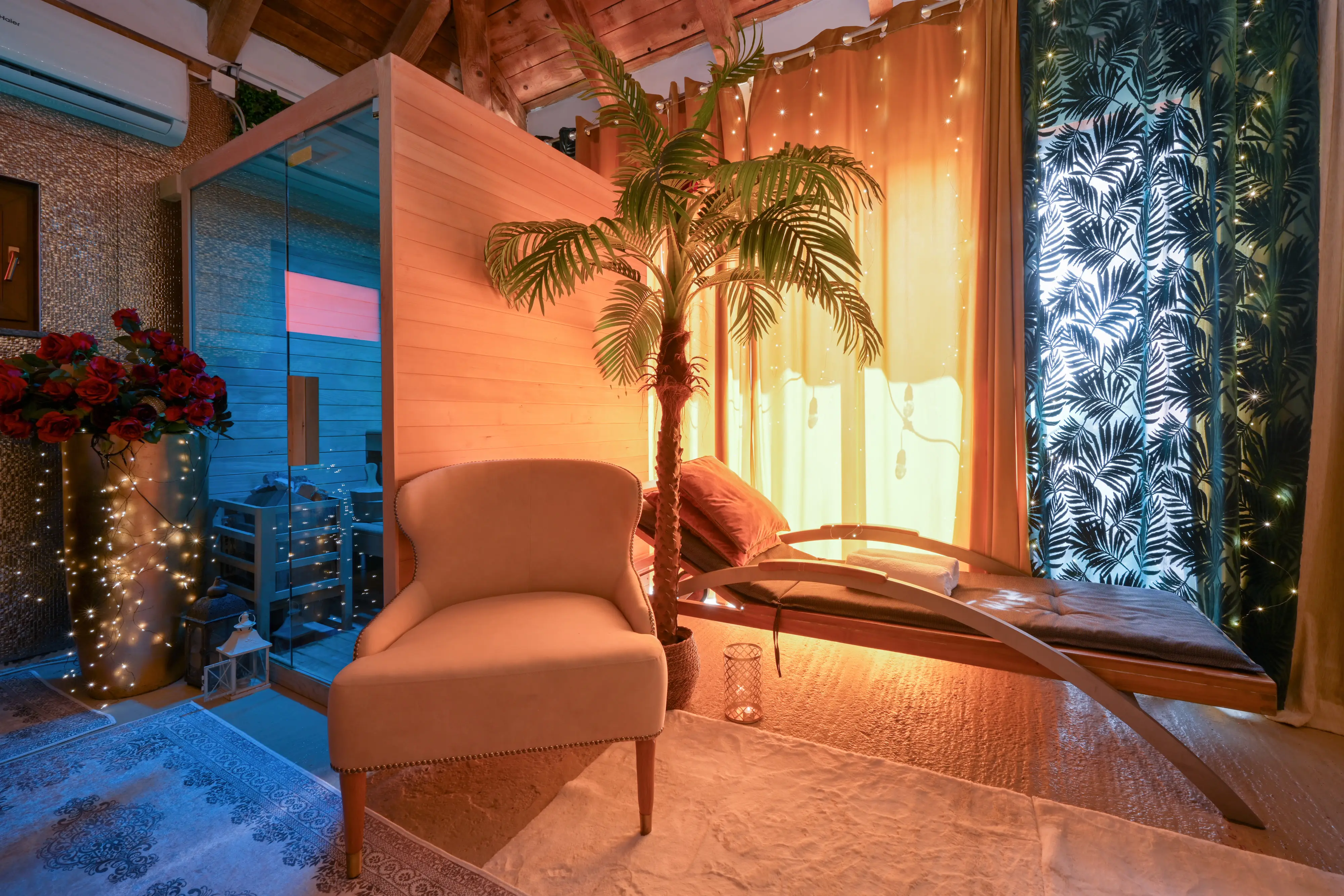 Lounge chair, palm, and jacuzzi edge in warm light