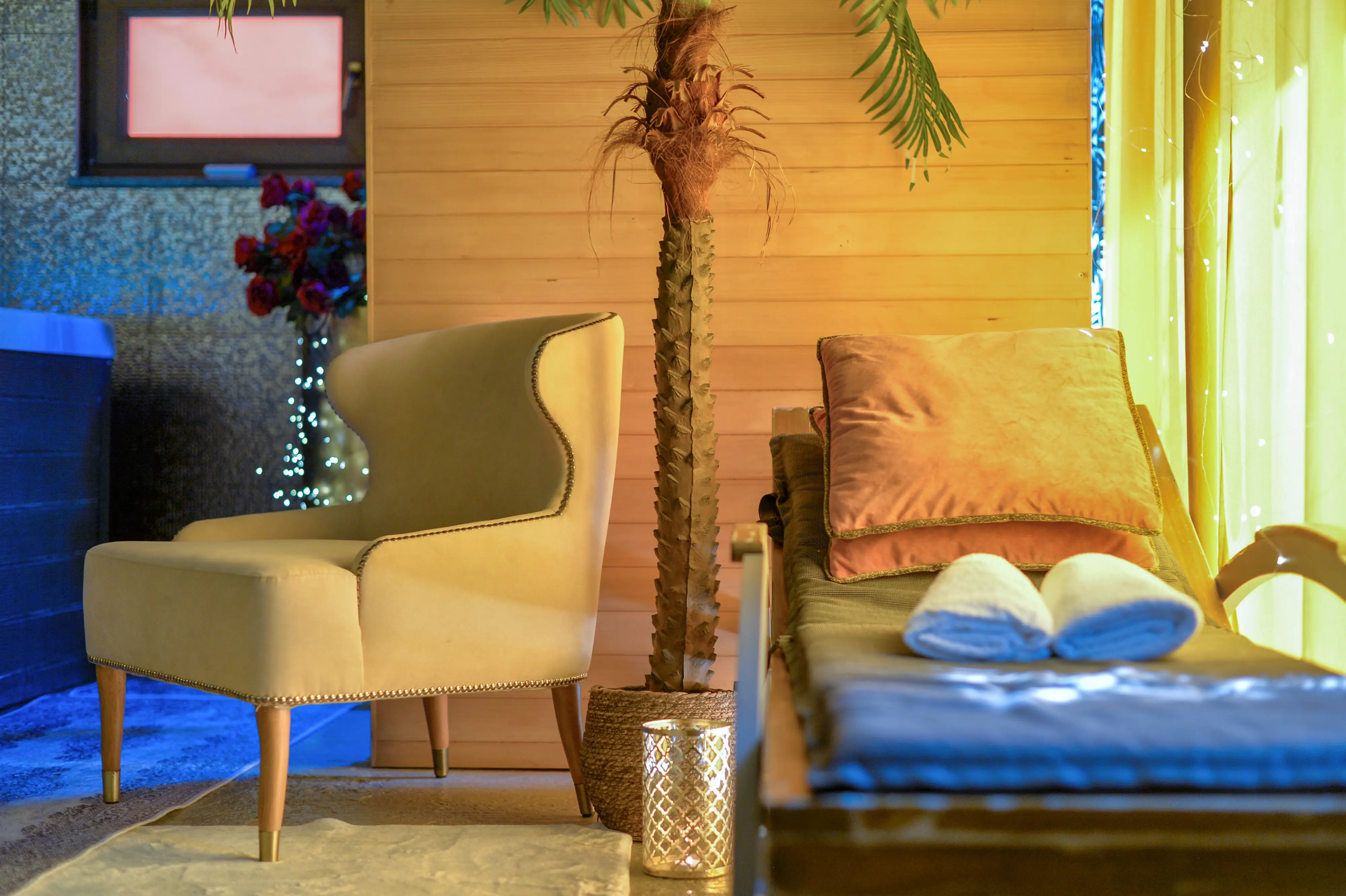 Slippers, lounger, and warm lamp beside jacuzzi