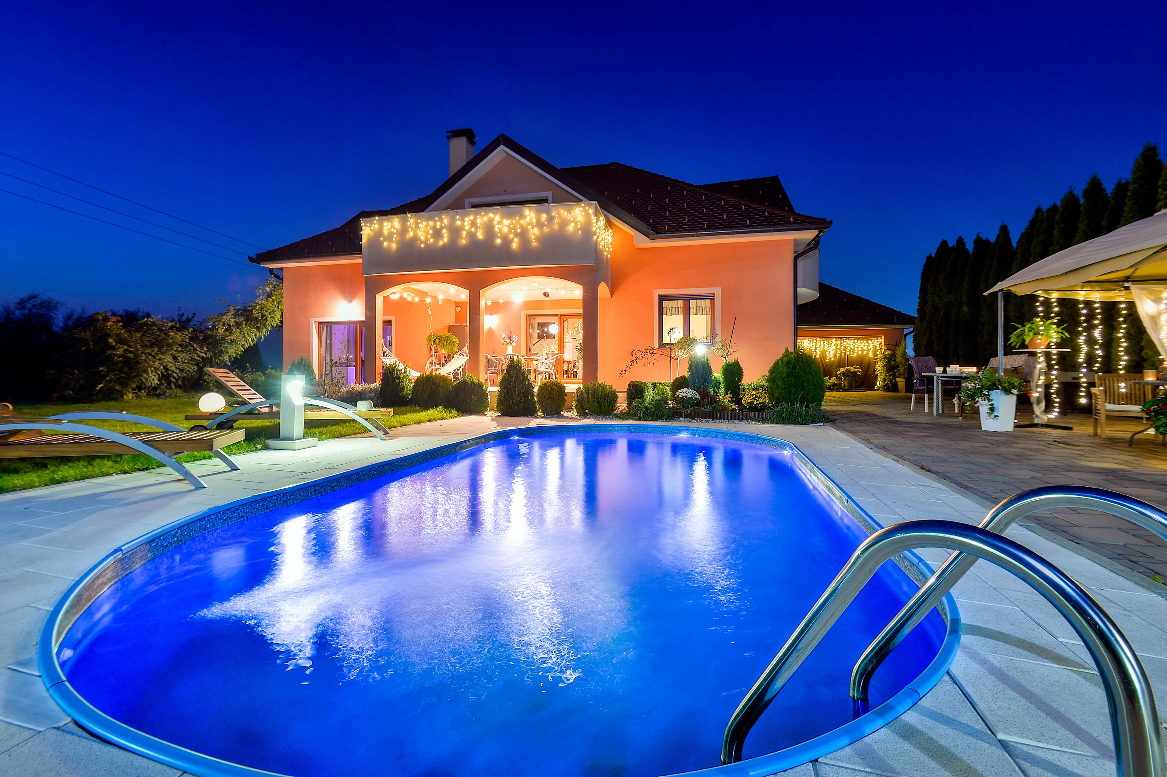 Front-facing night exterior with warm facade lighting