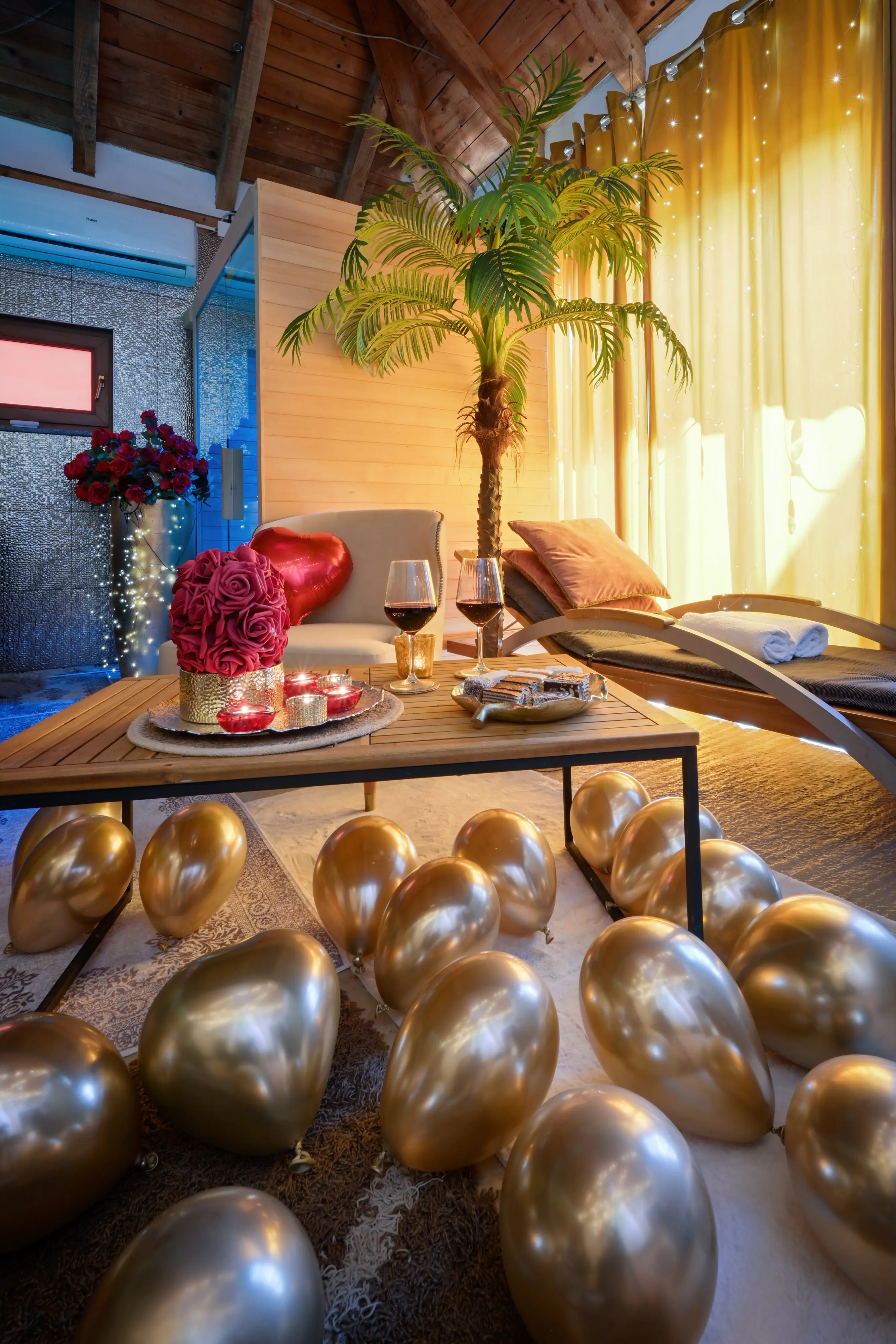 Wine glasses and roses on a warmly lit spa table